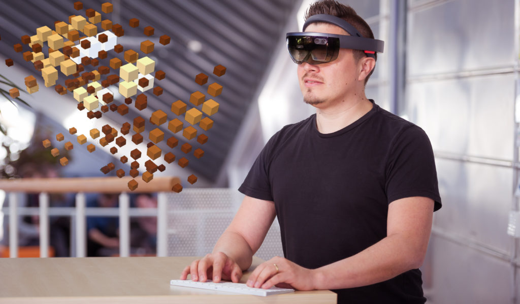 Man using Microsoft HoloLens® and a Bluetooth keyboard as input/output devices for interactive Visualizations